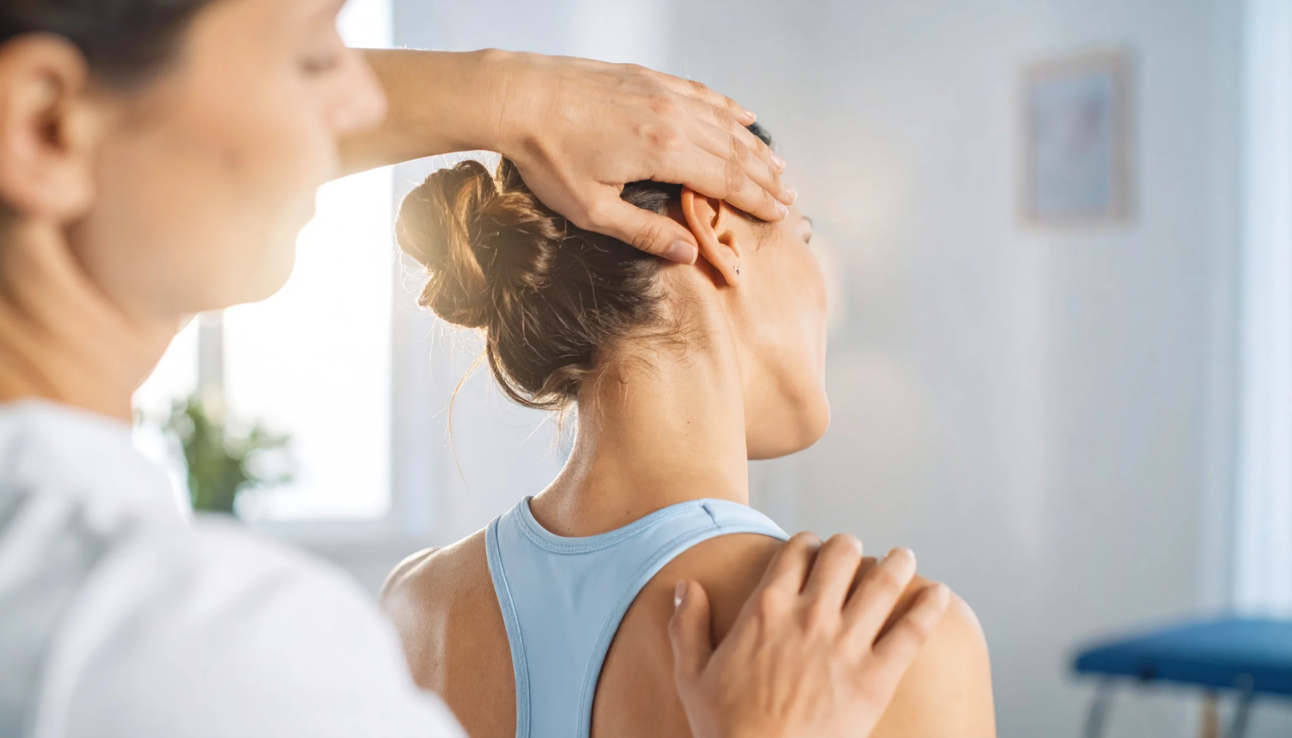 Doctor examining patient's cervical spine for neck pain treatment