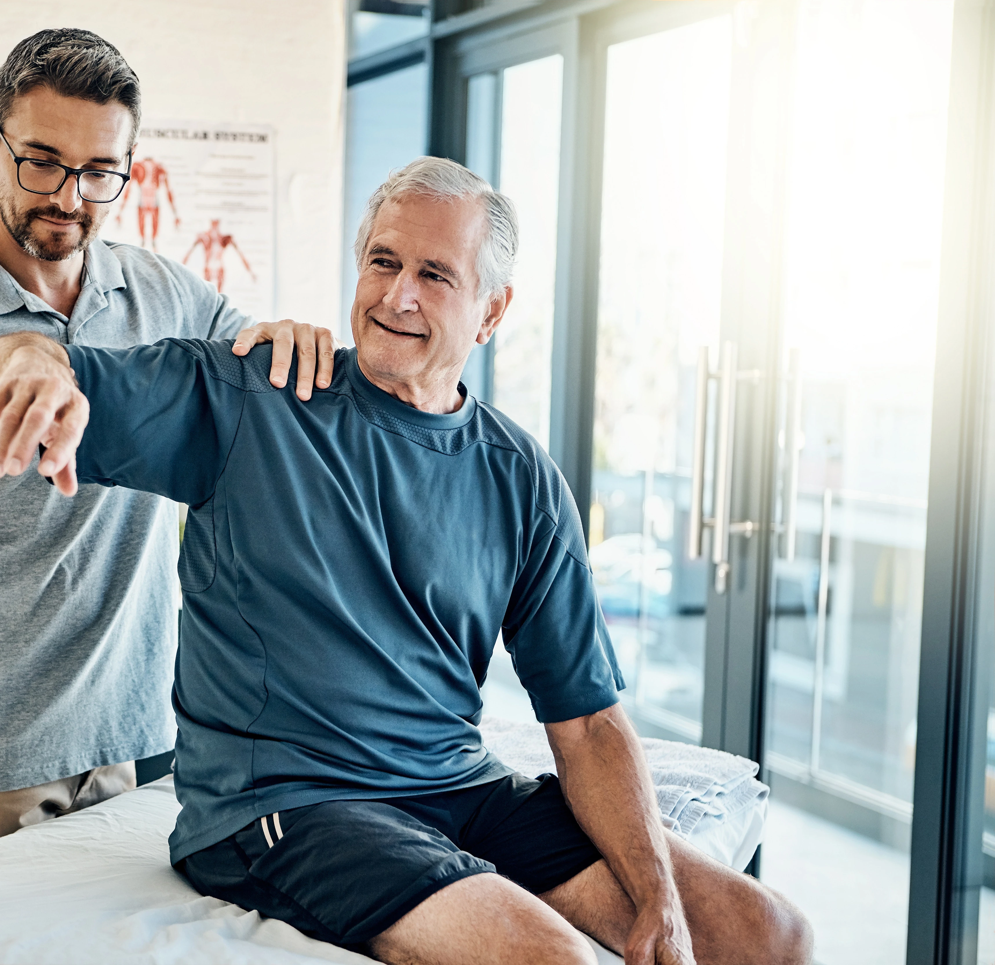 Physical therapist assessing a patient’s shoulder range of motion